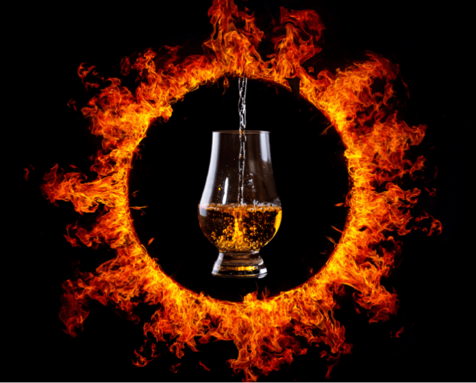 A glass of whiskey floats in the middle of the Mordor ring of fire, symbolizing the Mulberry MAX "Quest for the Precious" rare whiskey event.
